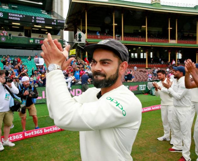 Virat Kohli acknowledges the crowd at the Sydney Cricket Ground after India's 2-1 test series win...