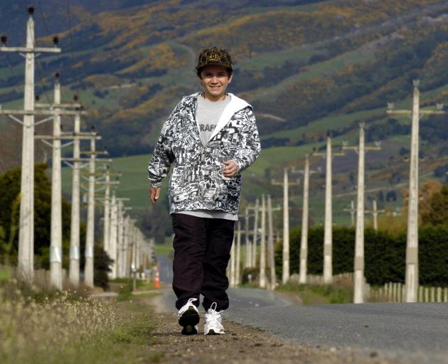 Harrison Kemp strides down Maungatua Rd, near Outram, in October 2008, in preparation for a 10km...