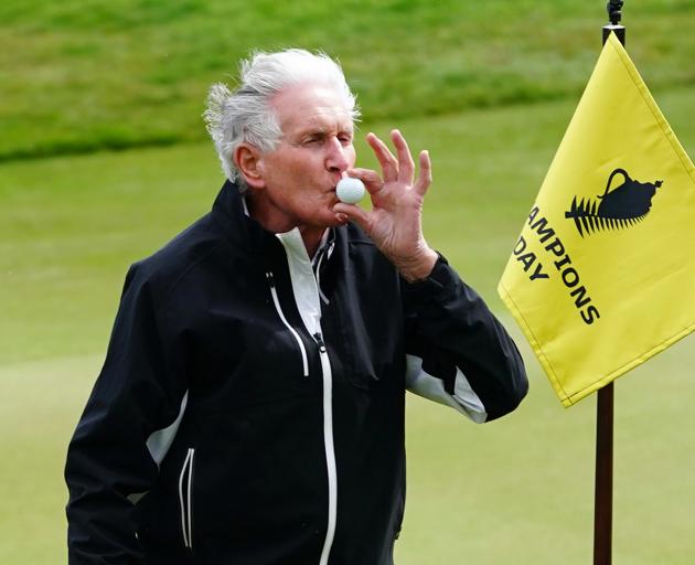 Golfing great Sir Bob Charles kisses a ball after nailing a hole-in-one at the par-three tournament at the Farm course, beside The Hills, yesterday.