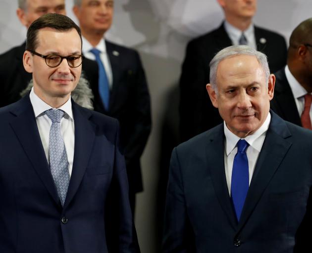 Poland's Prime Minister Mateusz Morawiecki and Israel's Prime Minister Benjamin Netanyahu look on...
