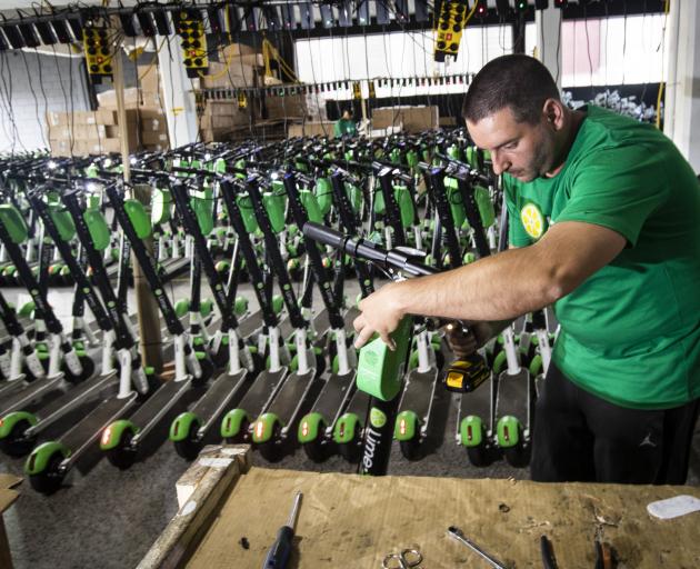 Mechanic Vlatko Jovanovski repairs Lime scooters in storage at Lime's warehouse in Kingsland, Auckland, this week. Photo: NZME