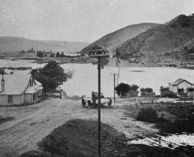 The flood at Ettrick, looking towards Millers Flat. The road bridge in line with the telegraph poles is completely submerged. - Otago Witness, 12.2.1919 