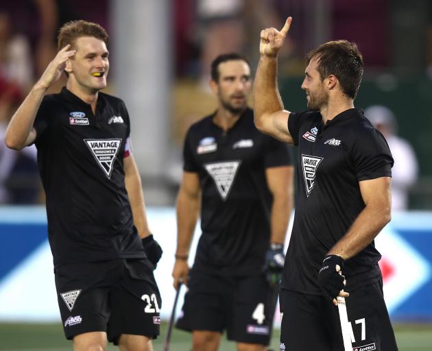 Nic Woods (right),  of New Zealand (right) celebrates his goal from a penalty corner during the...