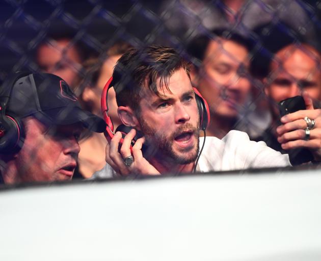 Matt Damon (left) and Chris Hemsworth watch on from ringside seats at UFC 234 in Melbourne. Photo...