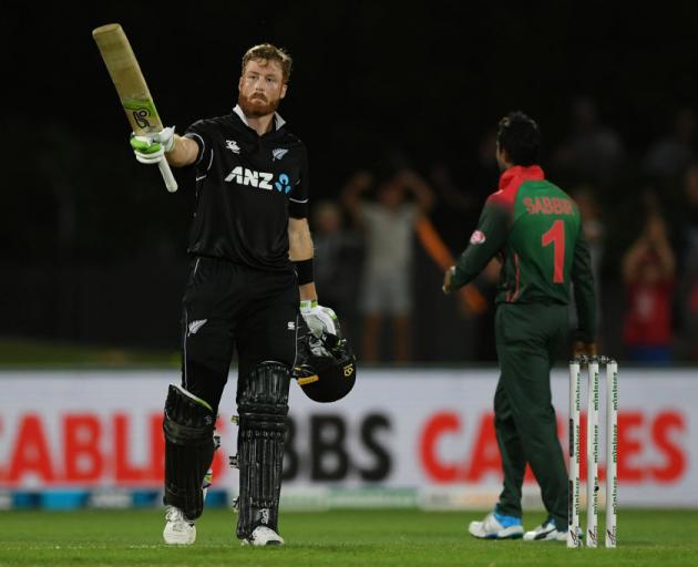 Martin Guptill of New Zealand celebrates scoring 100 runs during game one of the ODI series...