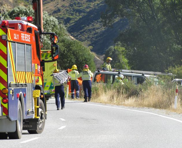 Emergency services work at the scene of a fatal crash on the Crown Range Rd yesterday afternoon....