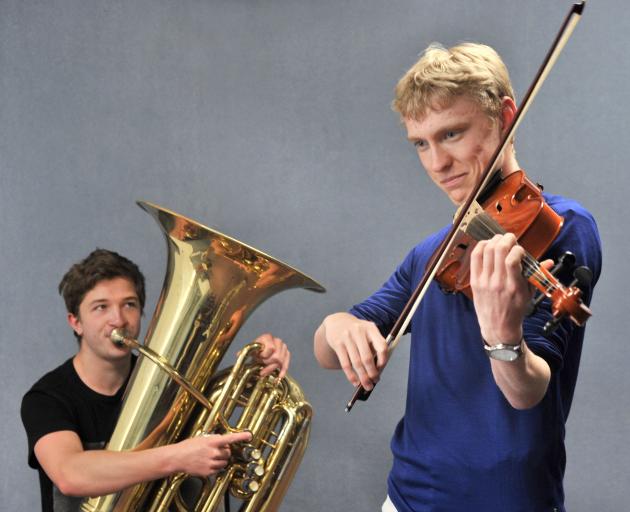 Logan Park High School tuba player Connor Bedwell (16) and violinist Cameron Monteath (17) start...