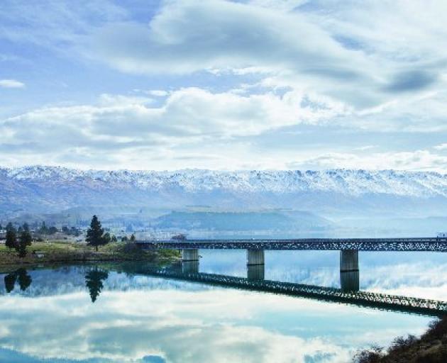 Slowing growth in global tourism; pictured, Maui camper vans owned by Tourism Holdings cross the bridge heading into Cromwell, Central Otago. Photo: Supplied
