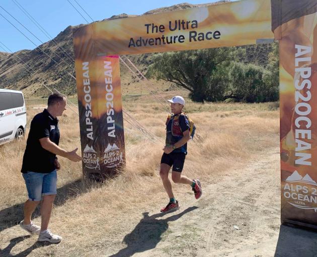 Alps 2 Ocean Ultra race director Mike Sandri greets Paul Hewitson as he crosses the 45km stage...