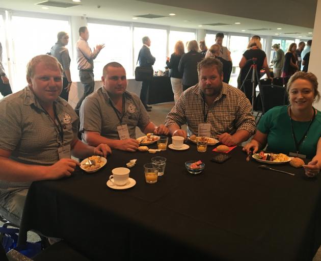 Sam Cooper (left) and Jeremy Madeley, of the Waimak Young Farmers Club (YFC), enjoy some breakfast while networking with Jason de Boo and Megan Hands, of the Dunsandel YFC, at the New Zealand Young Farmers national conference in Christchurch on Friday, Fe