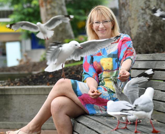 Dunedin resident Sophie Barker with threatened red-billed gulls, in Dunedin's Octagon. Photo: Stephen Jaquiery