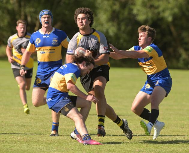 Vikings forward Josh Hill attempts to bust through some Taieri defenders in the final of the...