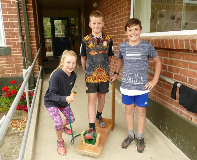 Meg Howard shows off her boot cleaner with Ben Cairns (centre) and Alfie Cowie (all 10). Photos: Ken Muir