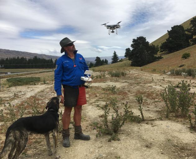 Tony Buchanan, of Bannockburn, with his dog, Wolf, often muster Central Otago hills with the help of a drone. The Lowburn Collie Club even added a drone component to its recent dog trials. Photo: Alexia Johnston
