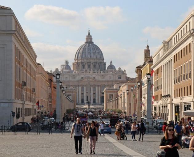 People walk the Via della Conciliazione leading to the Vatican City, in Rome. Photo: Reuters