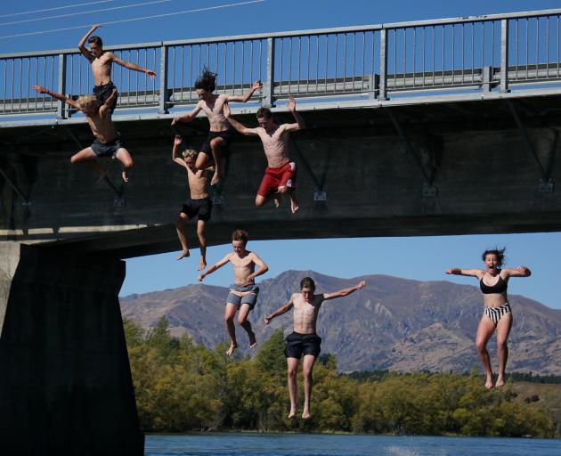 A group of Mount Aspiring College pupils jump off the Albert Town Bridge yesterday in defiance of...