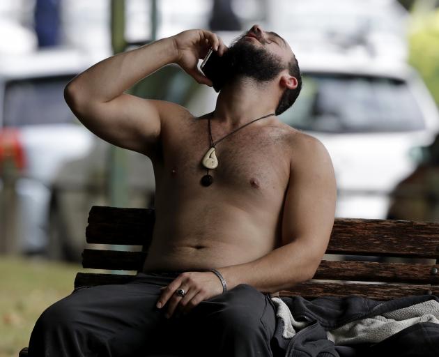 A man reacts as he speaks on a mobile phone outside a mosque in central Christchurch. Photo: AP