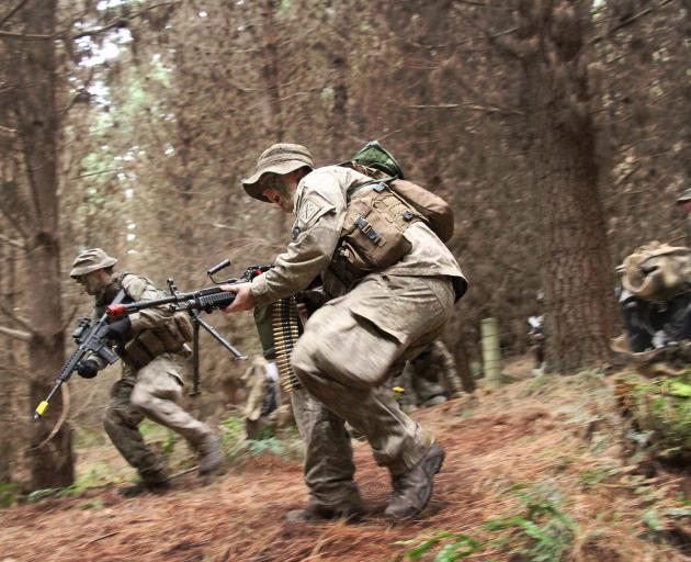 Soldiers race into cover as they are contacted by the ``enemy'' during their training exercise...