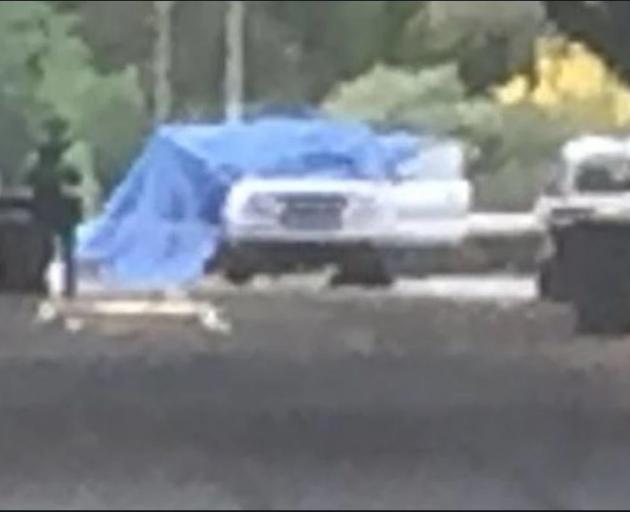 The police investigation is focusing on this white vehicle, covered by a blue tarpaulin. Photo: NZME