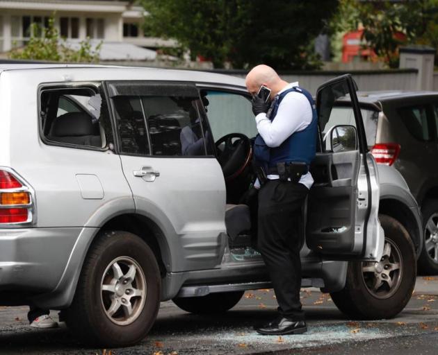 The driver's window, rear driver's side window and rear window are all smashed out. Photo: NZME