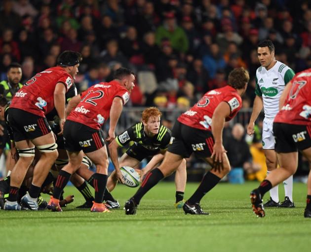 Finlay Christie clears the ball from a Hurricanes ruck as the Crusaders defensive line makes its...