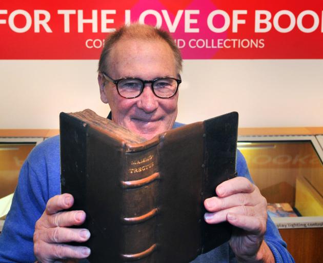 University of Otago special collections librarian Donald Kerr holds an old Latin book, which is part of a new exhibition, at the university's central library. Photo: Christine O'Connor