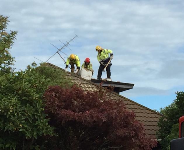 Firefighters are smash down a chimney after reports a man is trapped. Photo: Luisa Girao