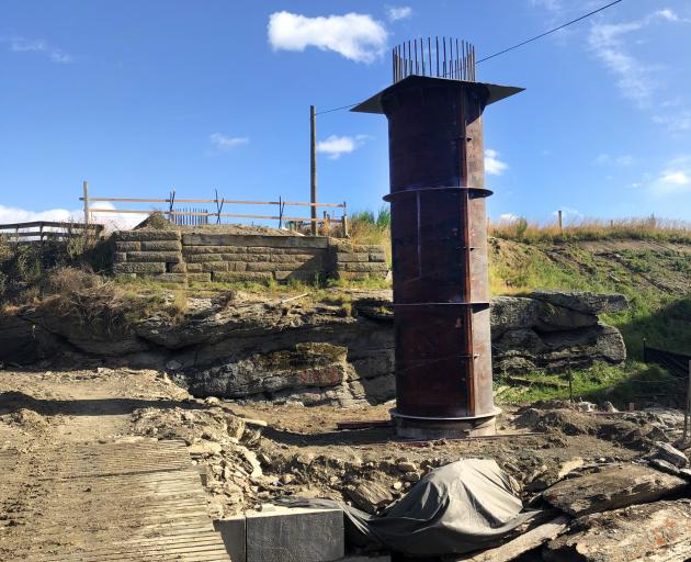 Recently poured concrete piles are in place for the new Sutton Bridge, while the old bridge...