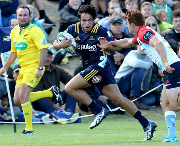 Josh Timu on the run for the Highlanders, who he has been training with, in a preseason match...