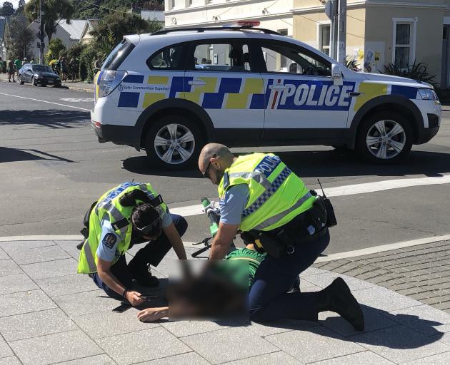 A man was placed into a recovery position by police before he was taken away in a St John...