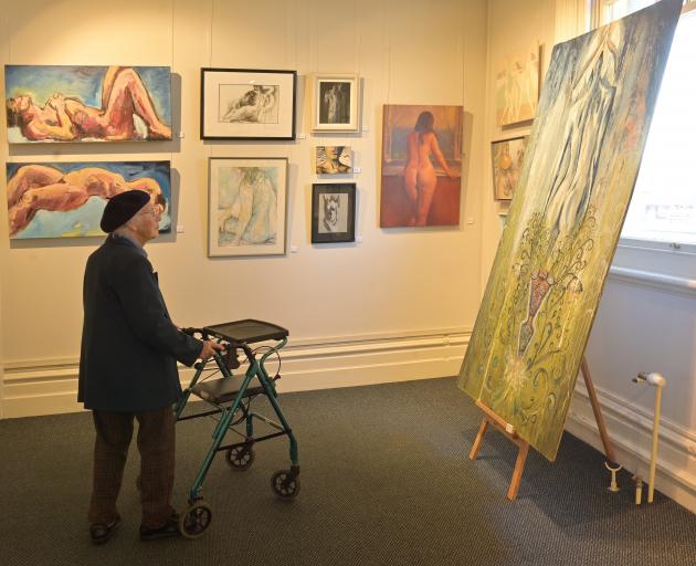 Honor McKellar, a resident of the Yvette Williams Retirement Village, appreciates art at The Nude...