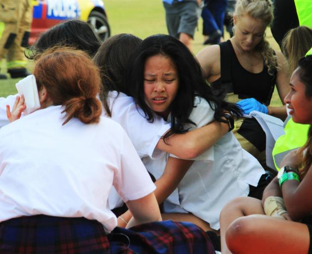 St Kevin's College year 11 pupil Leyanne Monoy (14) is comforted as she takes part in an emergency services exercise at the school yesterday. Photos: Hamish MacLean
