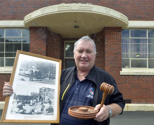 Maritime Union of New Zealand secretary Phil Adams packs sentimental items as he is evicted from his Port Chalmers office, including a photograph taken at the port in the 1950s, showing his grandfather Harry Adams and father-in-law Walter Meehan. Photo: G