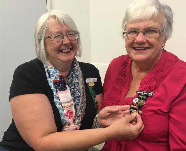 Mavis Wilkins, of Lowcliffe Women's Institute (WI), is given her WI 50-year pin by outgoing Mid Canterbury Federation of Women's Institutes president Jude Vaughan. Photo: Toni Williams