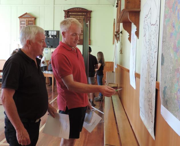 Noslam co-ordinator Rob McTague (left) and chairman Peter Mitchell discuss the map showing where testing will be carried out in the Waiareka catchment. Photo: Sally Brooker