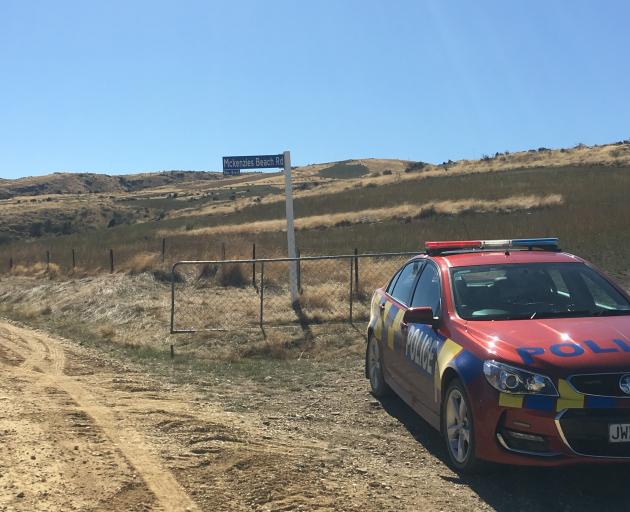 A police car at the cordon on Mckenzies Beach Rd. Photo: Adam Burns