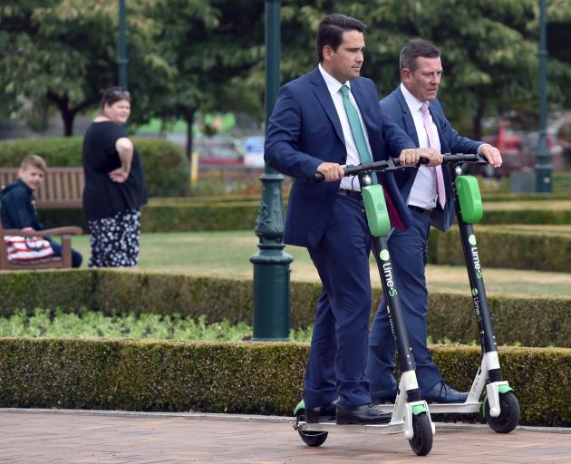 National Party leader Simon Bridges, middle, and Dunedin MP Michael Woodhouse, ride Lime scooters at Dunedin Railway Station yesterday. Photo: Gregor Richardson