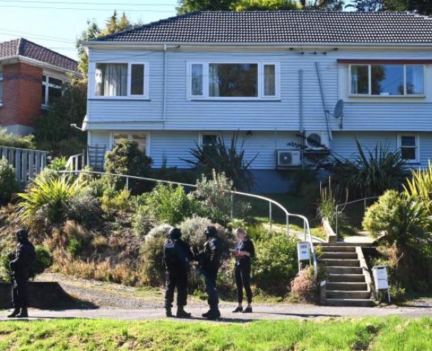 Police armed offenders personnel search the property in Somerville St, Dunedin, on Saturday....