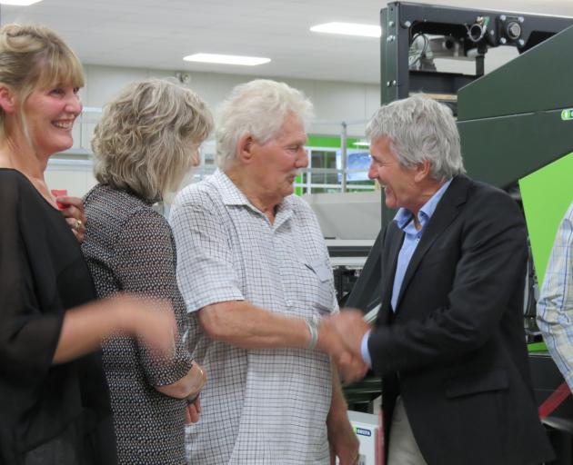 Orchard and packhouse owner Con van der Voort, of Ettrick, is congratulated by Minister of Agriculture Damien O’Connor (right), at the CAJ van der Voort packhouse in Ettrick. Watching the ribbon-cutting are daughter (from left) Jackie van der Voort and To