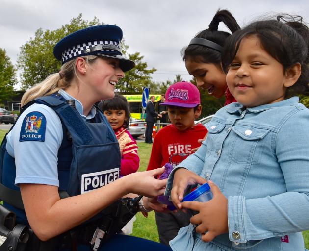  Const Sarah Brodie, of the Auckland Central Station, plays with (from left) Medha Nasrat Jahan (4), Suvo Rahman (4), Hafcha Akther (7) and Roha Rahman (3) in Hagley Park yesterday afternoon.