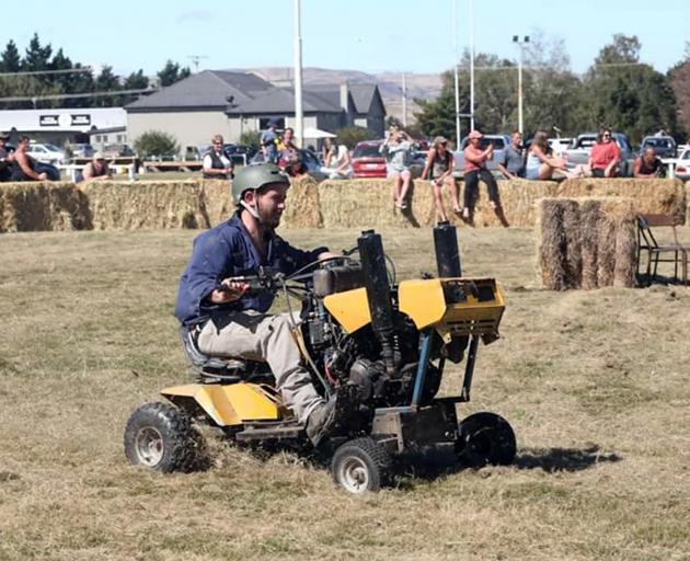 Local man Tom McCone takes part in a lawn mower race at the Strath Taieri A&P Show at Middlemarch...