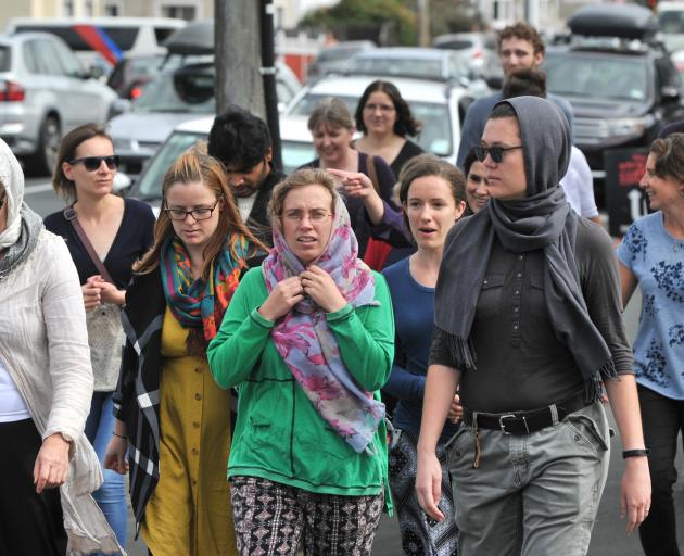 People head towards Al Huda Mosque ahead of a national call to prayer to mark those killed in the...