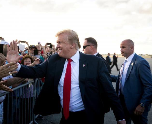 President Trump greeting supporters on the tarmac at Palm Beach International Airport, as he...