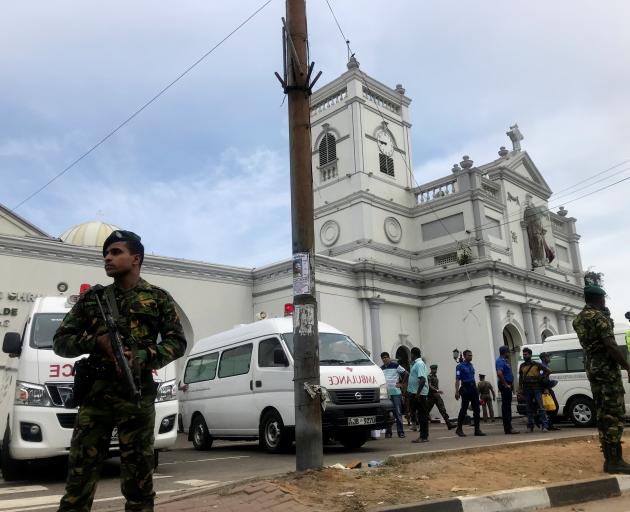 Sri Lankan military officials stand guard in front of the St. Anthony's Shrine, Kochchikade...