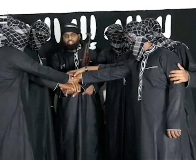A group of men purported to be the the Sri Lanka bomb attackers is seen at an unknown location in...