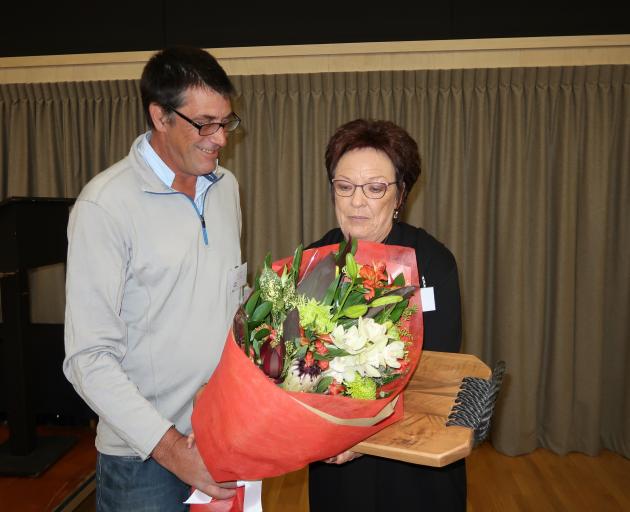 Sue Edgerton accepts her late husband Ewen 'Uge' Edgerton's posthumous life membership from Jim O'Malley. Photo: Mountain Scene