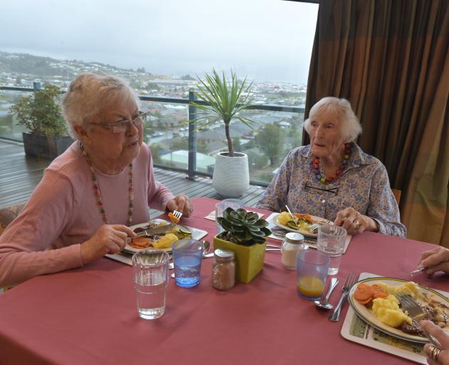 Residents Barbara Chilman (left) and Betty Kensington enjoy their lunch in the Rest Home at...