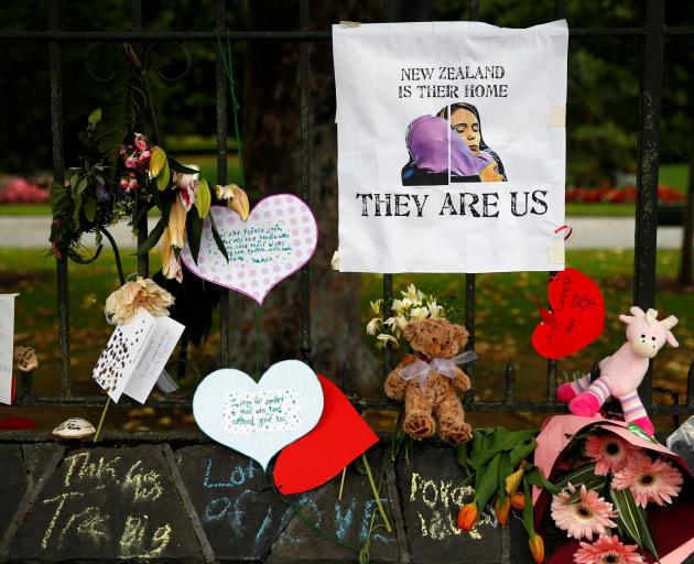Flowers and signs are seen at a memorial site for victims of the mosque shootings, at the Botanic Gardens in Christchurch, in March. Photo: Reuters
