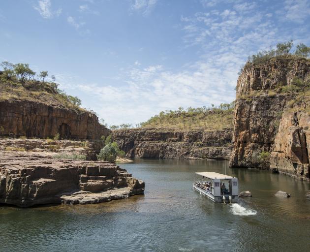 A tourist boat travels through the Nitmiluk Gorge, near Katherine, during a Ghan off-train...