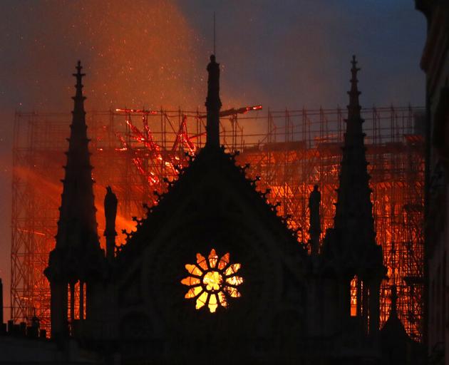 Flames and smoke rise from Notre Dame cathedral as it burns in Paris. Photo: AP